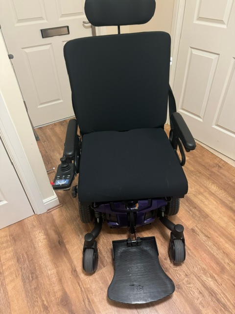 A Powered wheelchair in a hallway